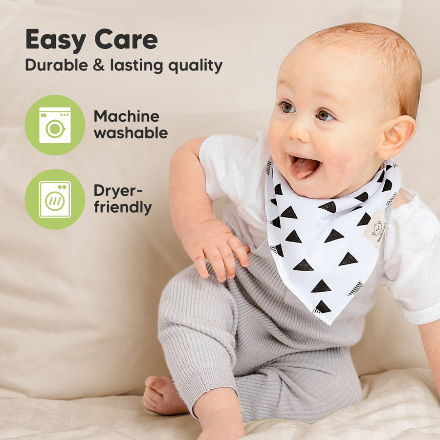 Baby wearing a black and white triangle patterned bib with text about easy care and machine washability.
