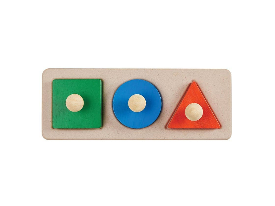 Wooden block puzzle with green square, blue circle, and red triangle on a beige base.