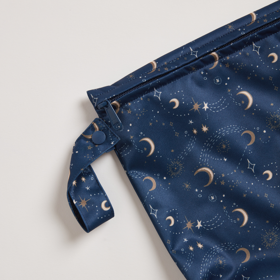 Navy blue pouch with celestial pattern on a light gray background