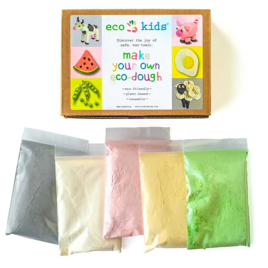 Picture of the Eco Kids make your own Eco-Dough box, which is brown cardboard with a label showing illustrations of play dough creations, and ziplock bags of colored powder in black, white, pink, yellow, and green. The text on the label reads 
