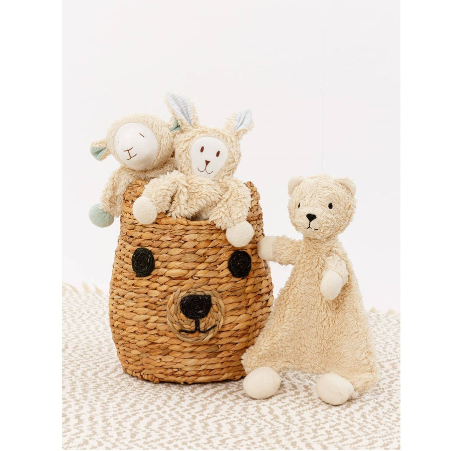 picture of the bear lovey next to a bear face shape wicker basket with a lamb and bunny lovey in it