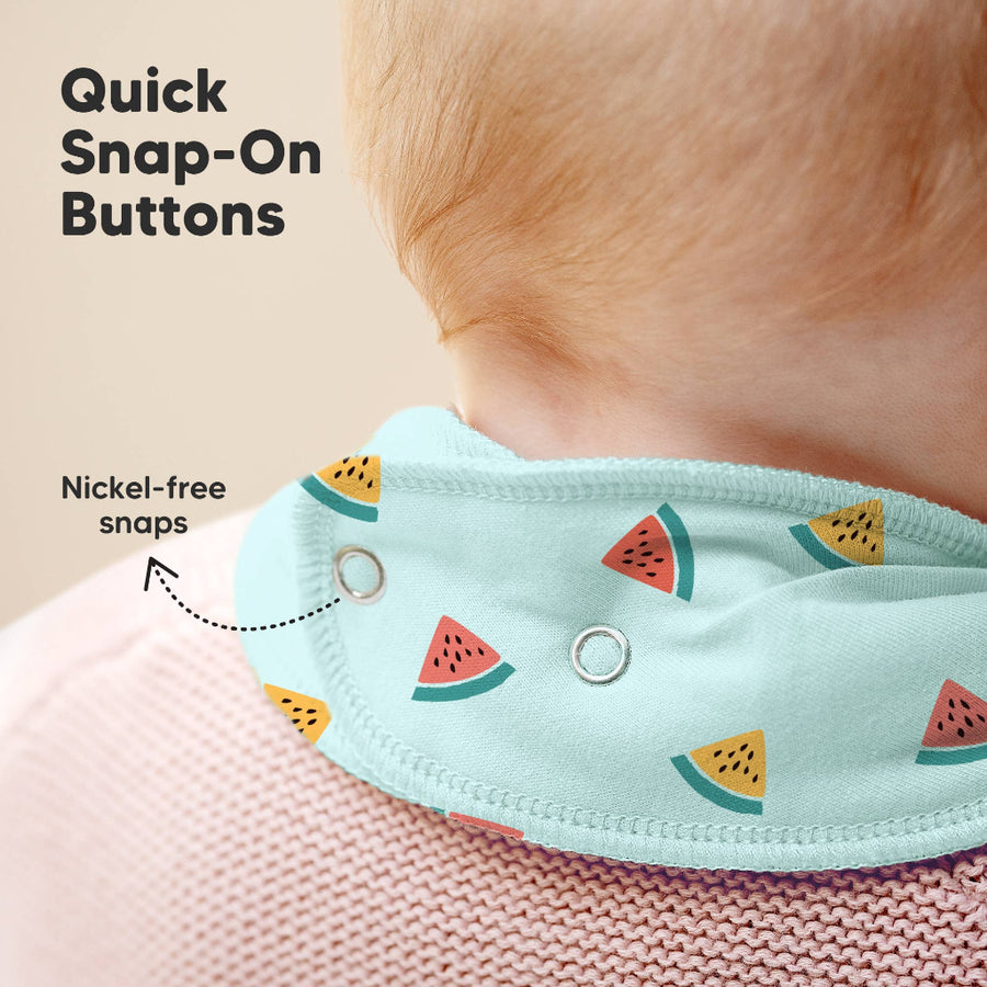 Baby wearing a bib with watermelon pattern and quick snap-on buttons, on a plain background.