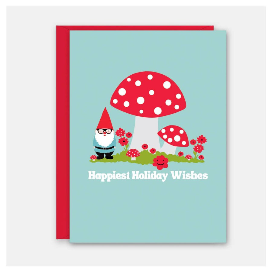 Picture of the card and envelope. The envelope is red. The card has a light blue background featuring red and white amanita-style mushrooms and red flowers sprouting from a patch of green grass, with a gnome standing under the largest mushroom. He is wearing a red pointed hat, glasses, blue tunic, black belt, black pants, and black boots and has a long white beard. Text in white reads, 