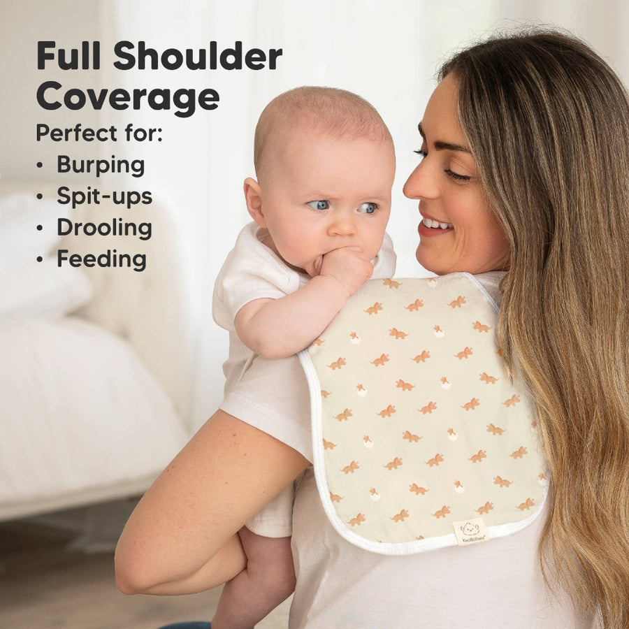 Woman holding a baby wearing a bib with text about full shoulder coverage.