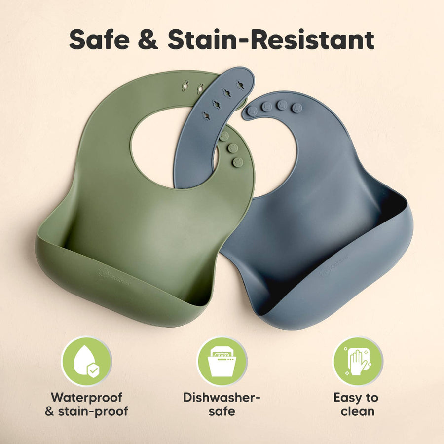 Two silicone bibs, one green and one blue, on a beige background with text 'Safe & Stain-Resistant'.