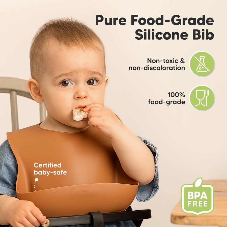 Baby wearing a brown silicone bib with text about its safety features on a beige background