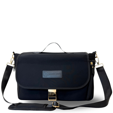 A black Maddy Caddy breast pump crossbody bag with a shoulder strap and a logo on the front.