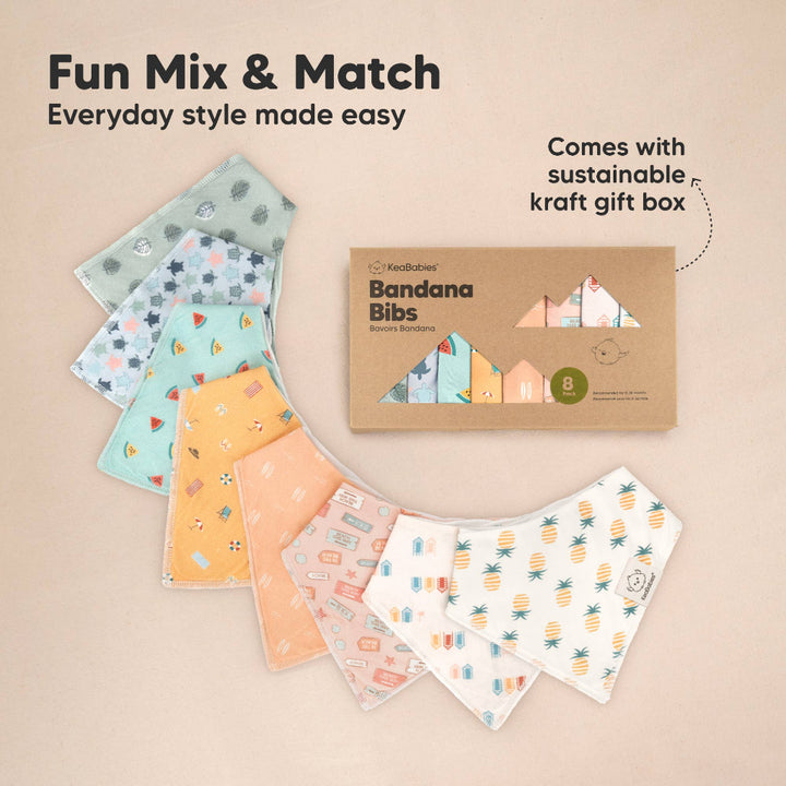 Set of colorful bandana bibs with a cardboard box labeled 'Bandana Bibs' on a beige background.