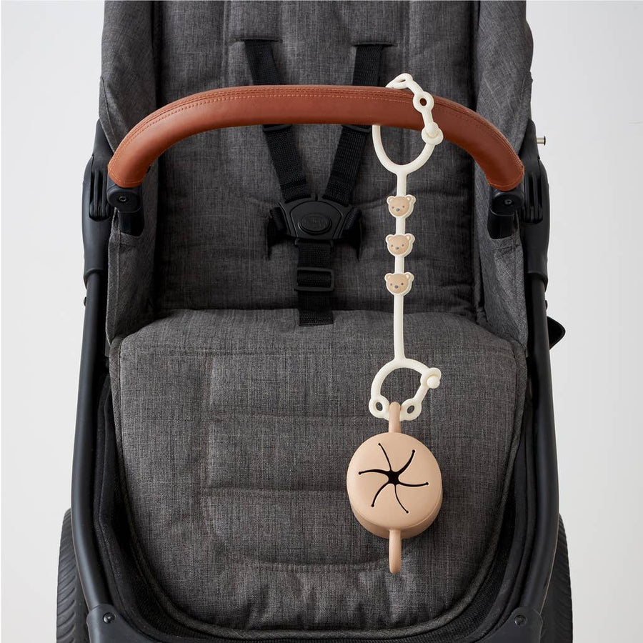 Stroller with a hanging baby toy attached to the handle