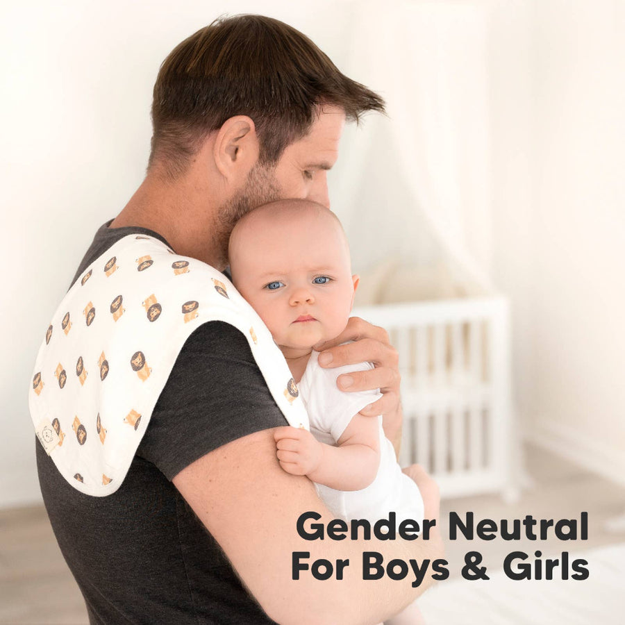 Man holding a baby with a patterned wrap, set against a neutral background.