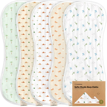 Set of four soft muslin burp cloths with different patterns on a white background.