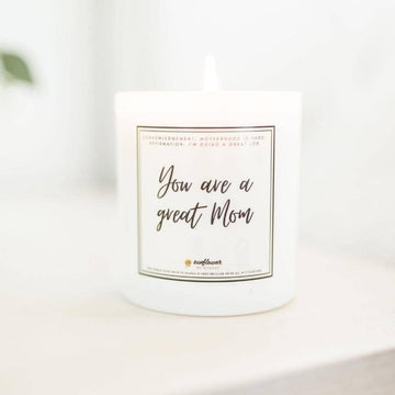 Image shows the Great Mom candle on a white surface that is blurry