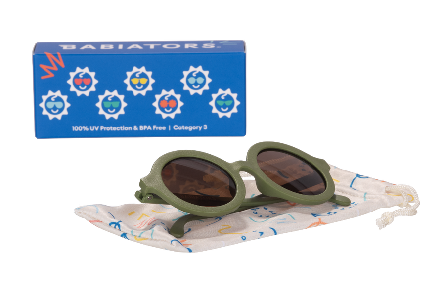 Green sunglasses with a colorful drawstring bag and blue Babiators box on a white background