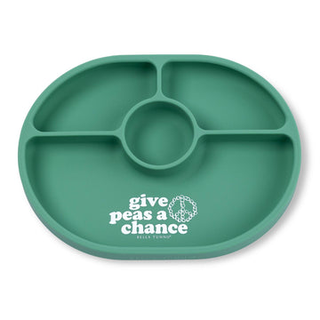 Green divided plate with 'give peas a chance' text on a white background