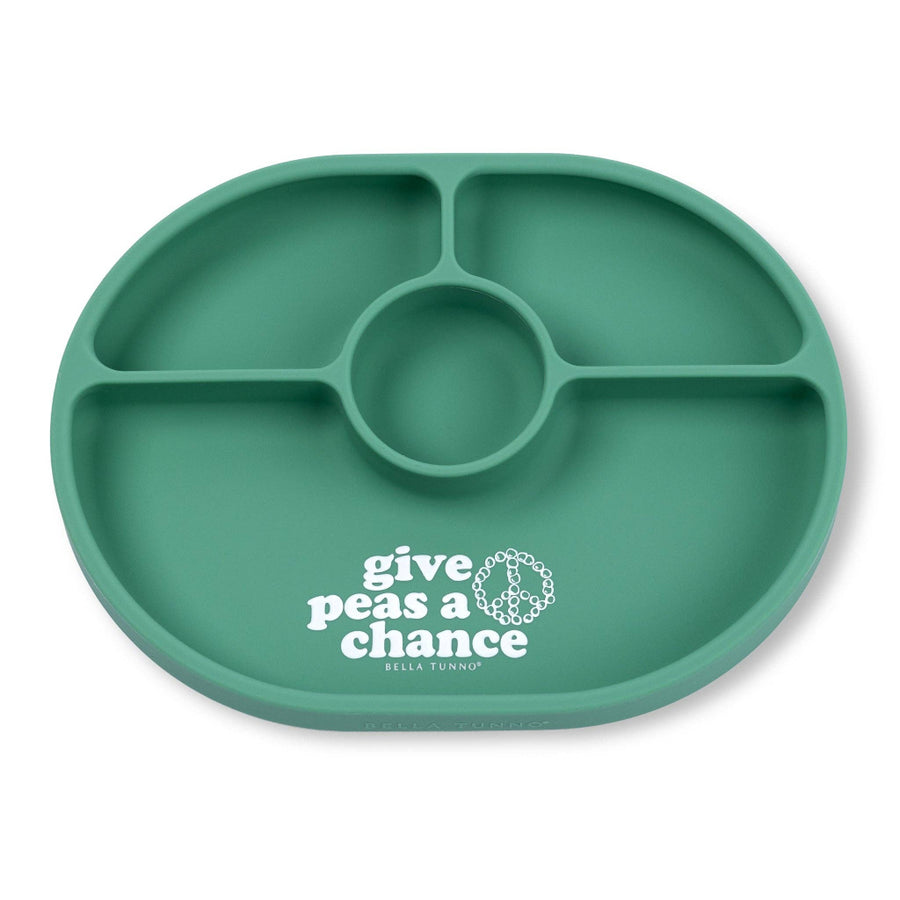 Green divided plate with 'give peas a chance' text on a white background