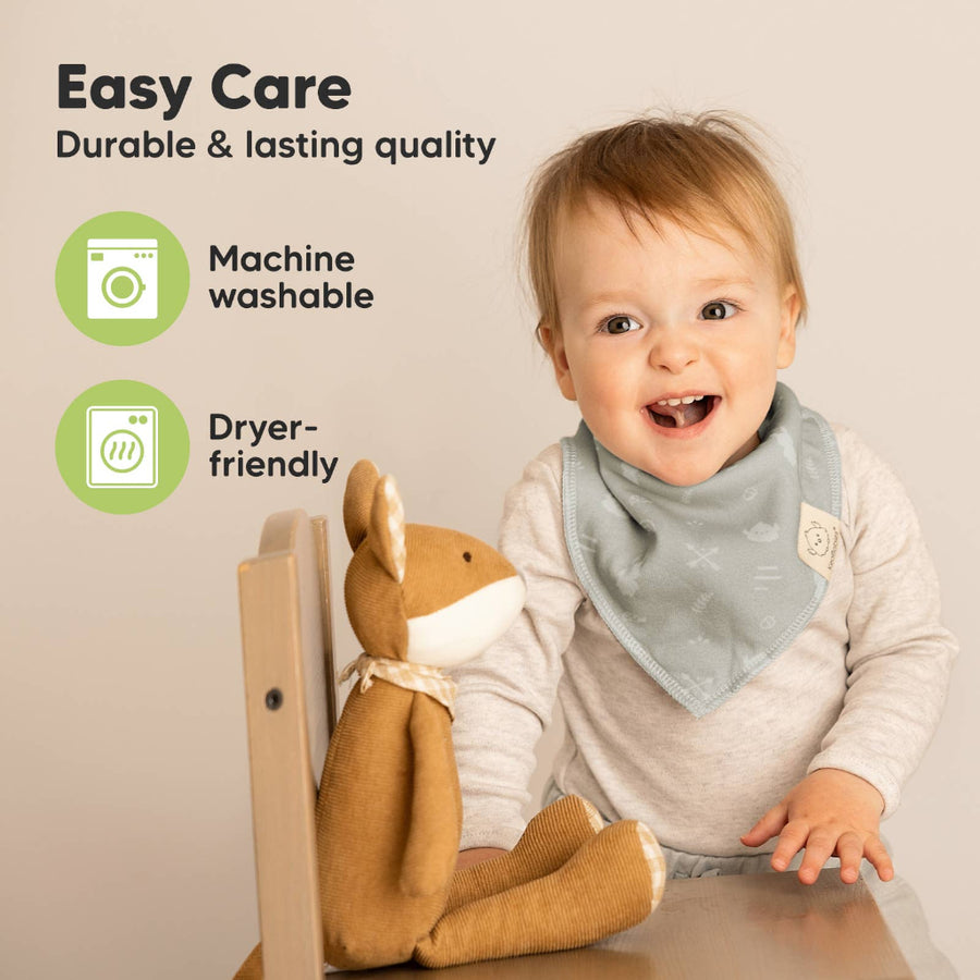 Child wearing a bib with text about easy care and machine washability.