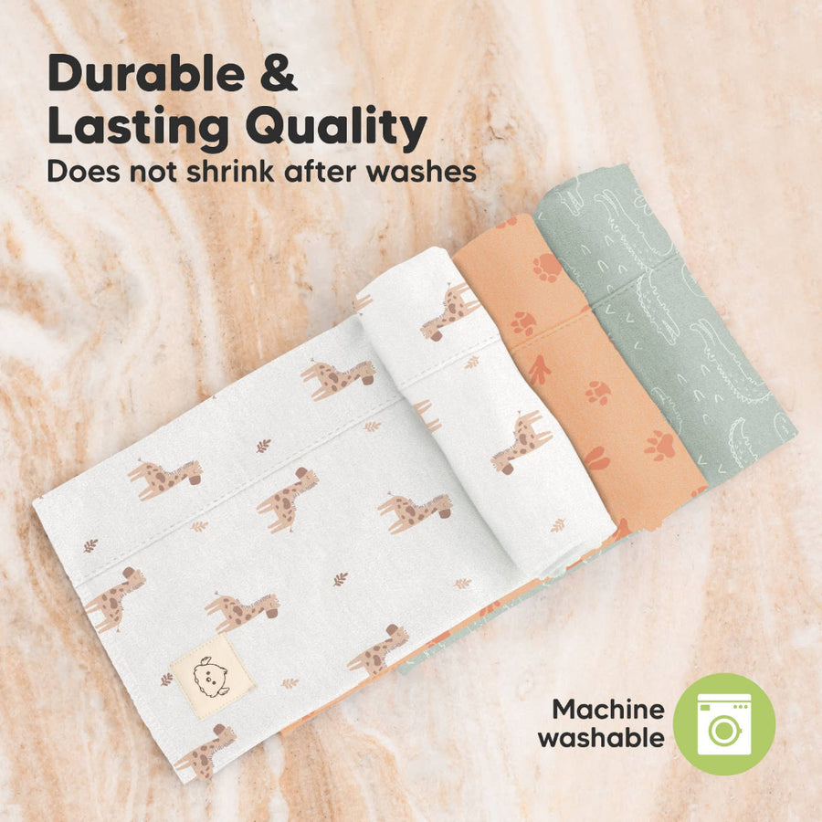 Three burp cloths with animal patterns on a wooden surface, labeled 'Durable & Lasting Quality' and 'Machine washable'.