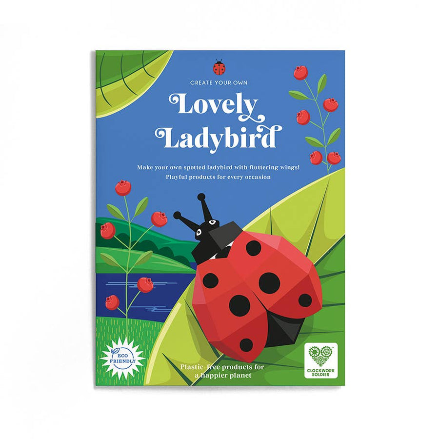 Image shows the packaging envelope for the Create Your Own Lovely Ladybird. It has a picture of the assembled ladybug on an illustrated leaf by a waterway with red flowers. Text on the envelope reads 