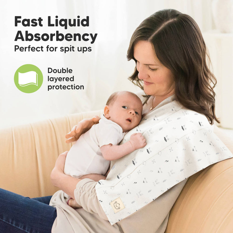 Woman holding a baby with a product labeled for fast liquid absorbency and double-layered protection.