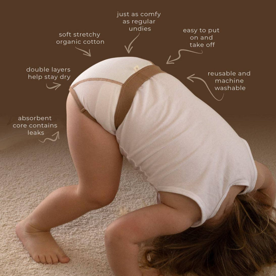 Child wearing a diaper with text highlighting features on a brown background