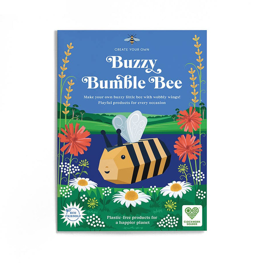 Image shows the packaging envelope for the Create Your Own Buzzy Bumble Bee. It shows a picture of the assembled bee visiting some flowers in front of a lake and green rolling hills. The text on the envelope reads 