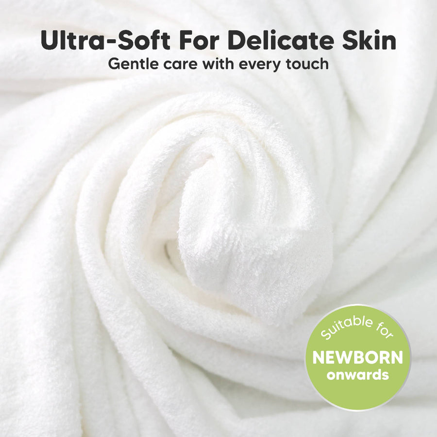Close-up of white fabric with text about ultra-softness for delicate skin and suitability for newborns.