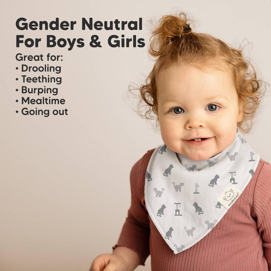 Child wearing a bib with text about its uses for boys and girls.