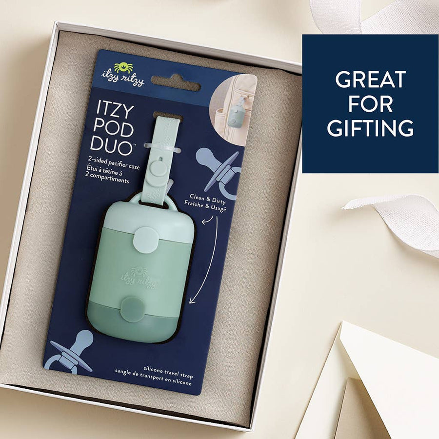 Itzy Pod Duo pacifier case packaging with a blue label on a beige background