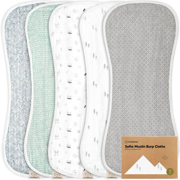 Set of five soft muslin burp cloths with different patterns on a white background.