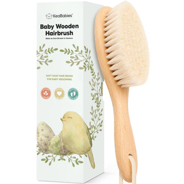Baby wooden hairbrush with packaging featuring a bird illustration on a white background