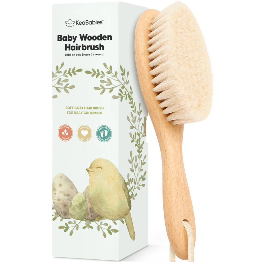 Baby wooden hairbrush with packaging featuring a bird illustration on a white background