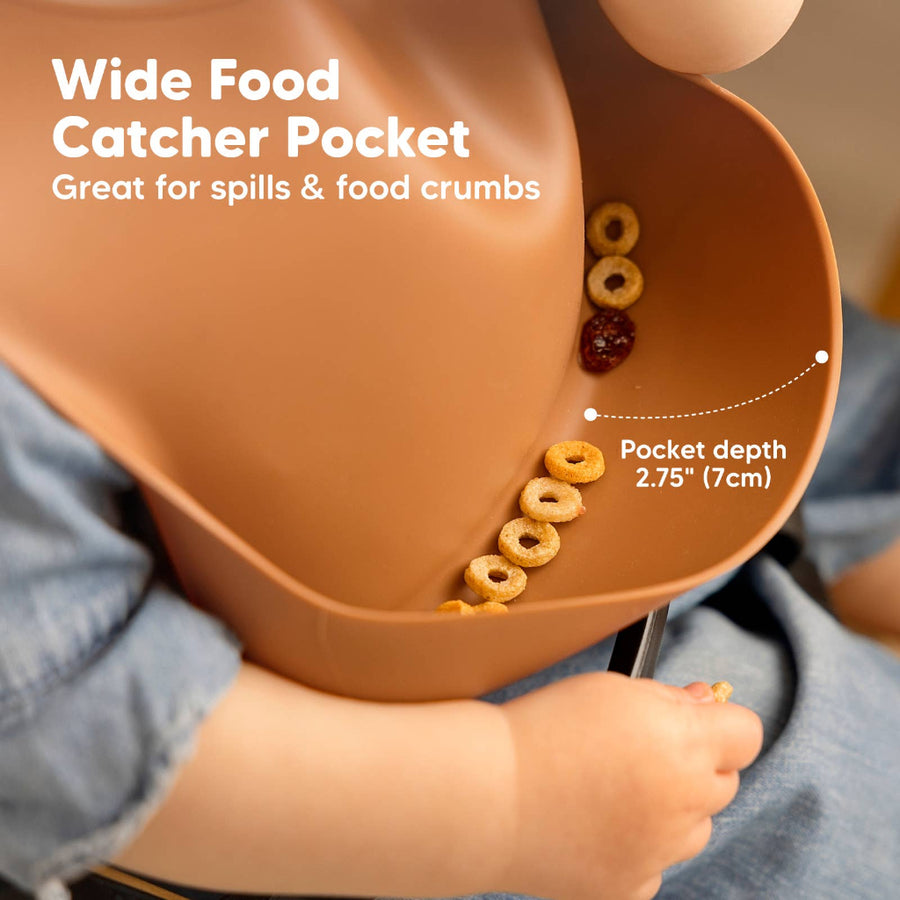 Wide food catcher pocket on a high chair with cereal and a hand reaching in, showing its depth.