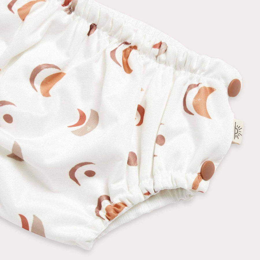 White diaper with brown crescent moon pattern on a white background