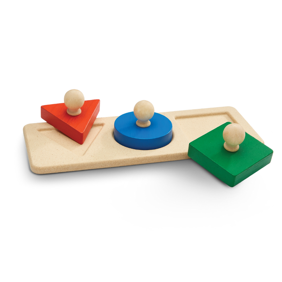 Color sorting toy with wooden blocks on a white background