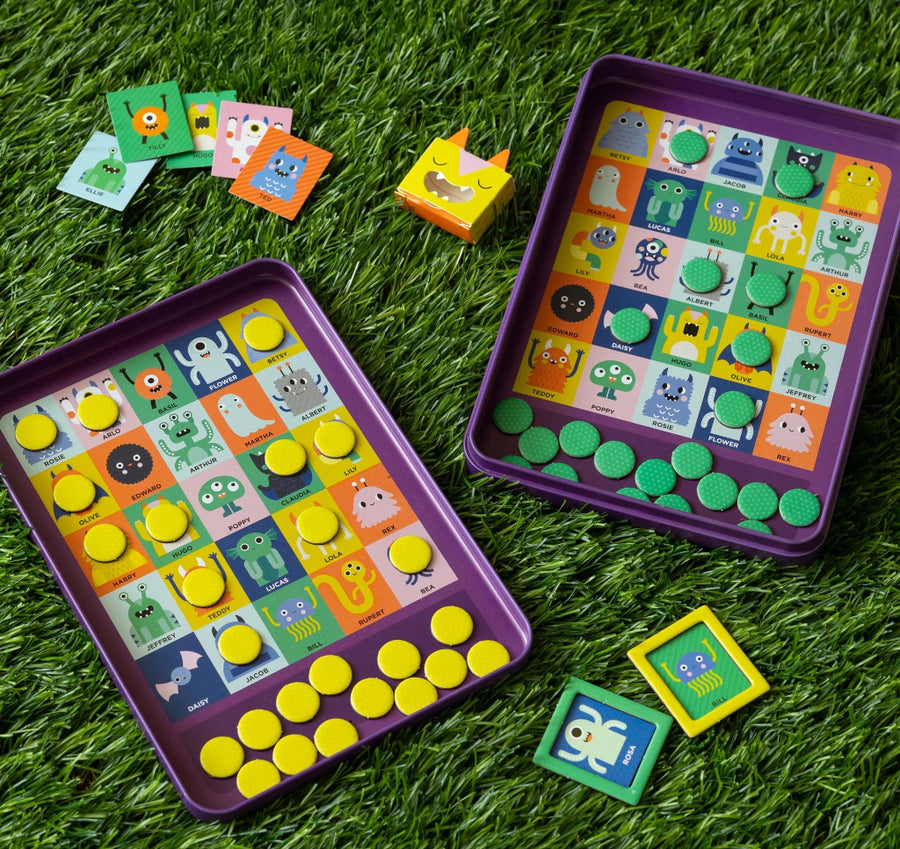 Children's educational game with colorful buttons and cards on a grass background