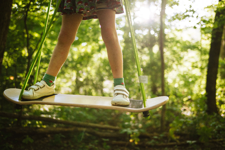 Person on a swing in a forest