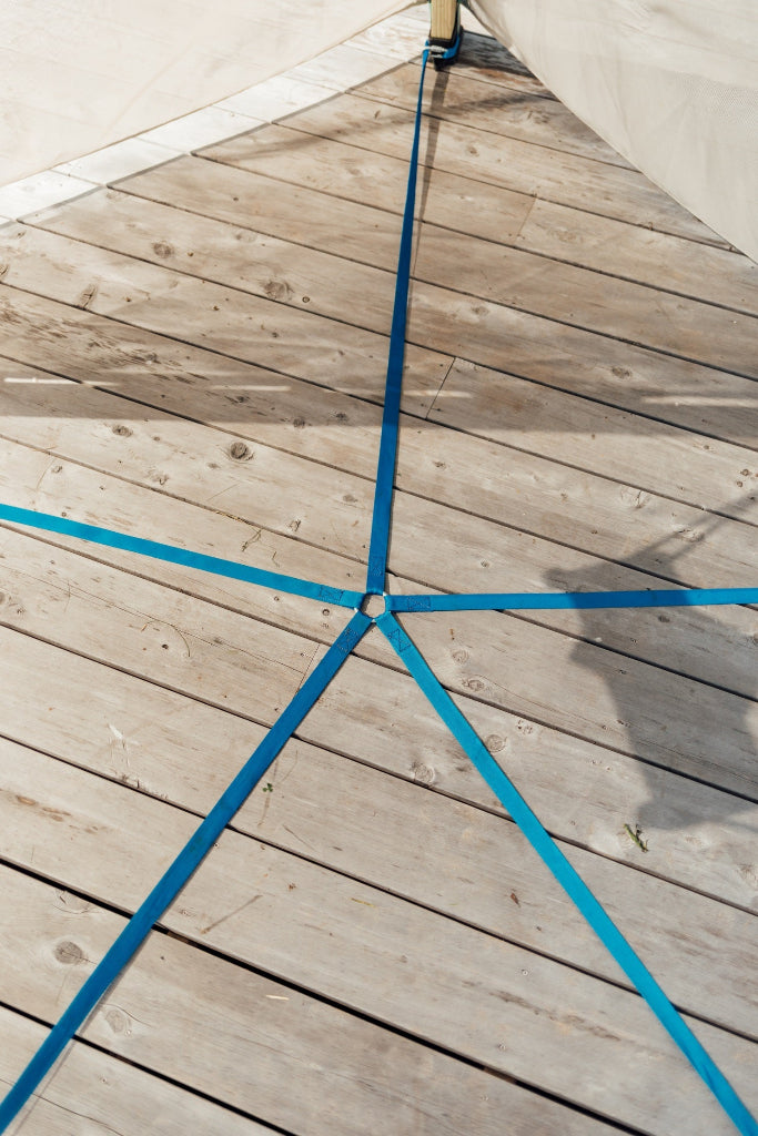 Wooden deck with blue ropes forming a star pattern