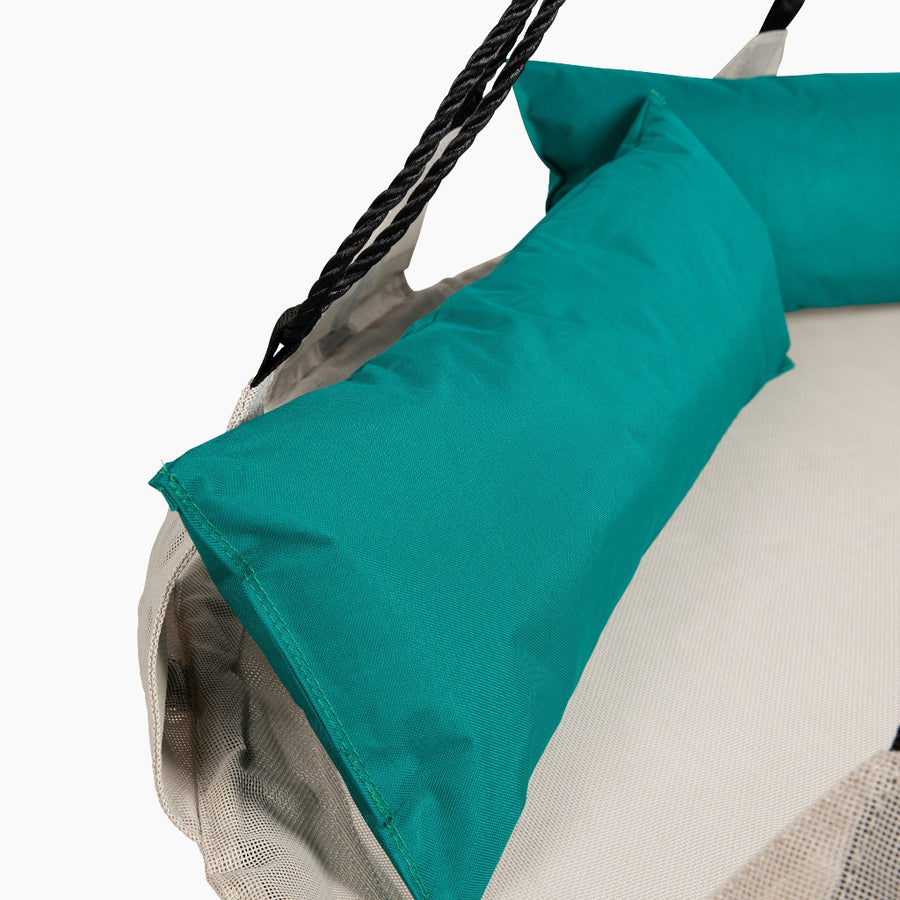 Close-up of a teal and beige hammock with a white background