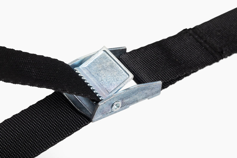 Close-up of a black strap with a metal buckle on a white background