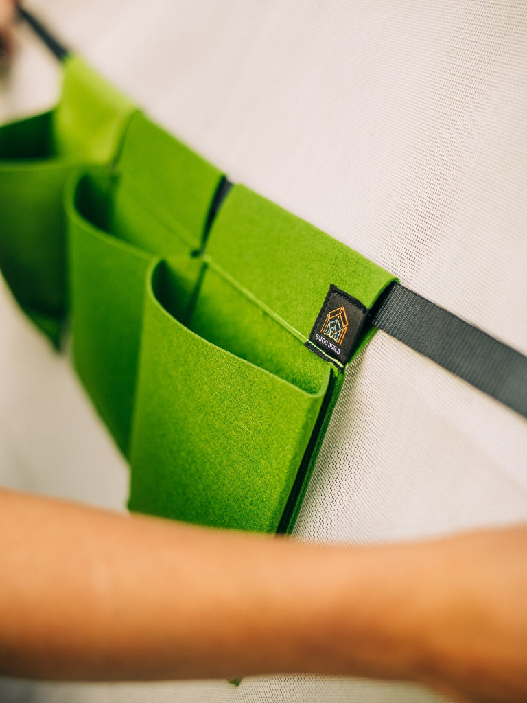 Green belt with multiple pockets and a brand logo on a white background