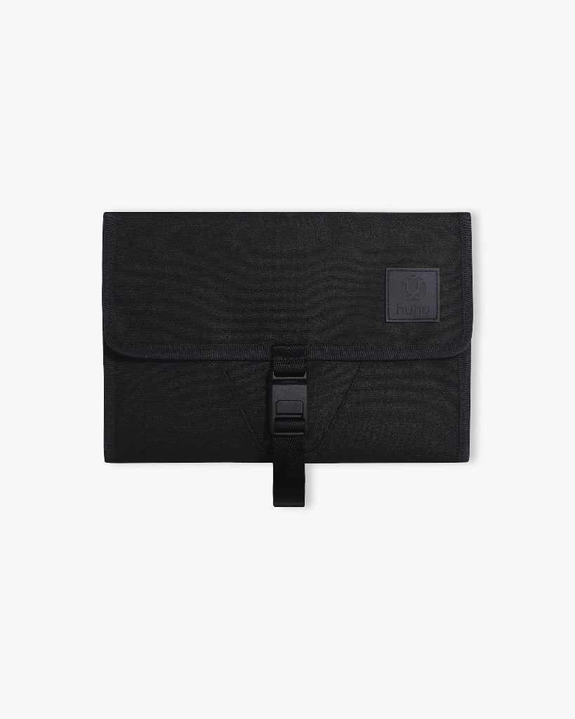 Front view of the black changing wallet against a white surface