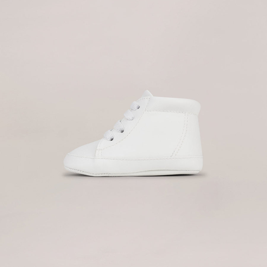 White high-top sneaker on a beige background