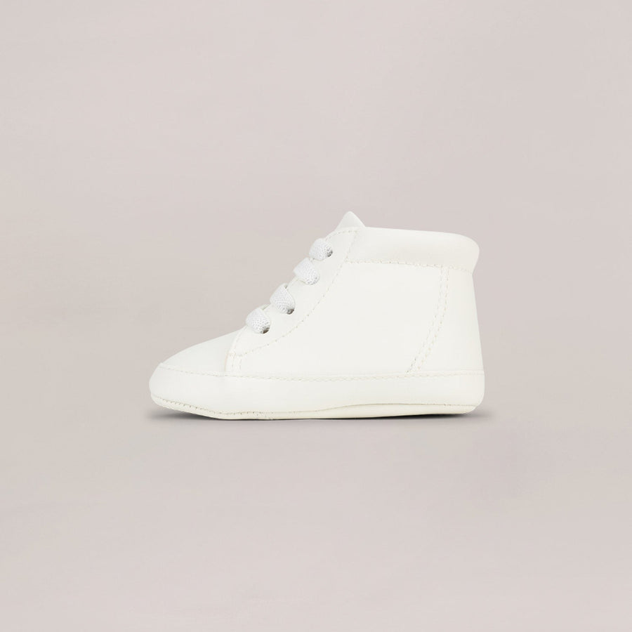 White high-top sneakers on a light gray background