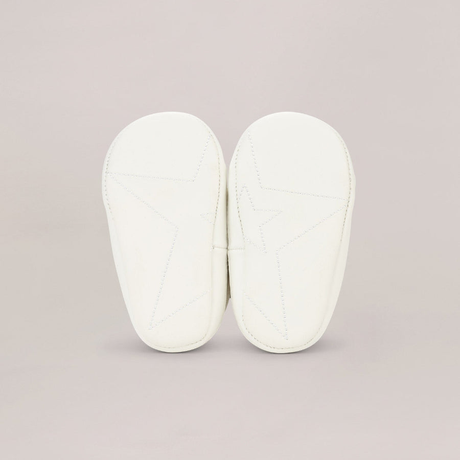 Pair of whitesoled shoes on a light gray background