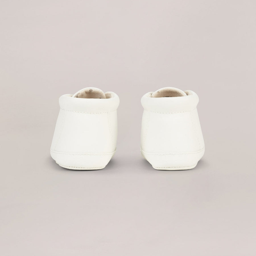 Two white high top shoes on a light gray background