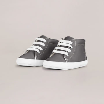 Pair of gray high-top sneakers with white laces on a light gray background