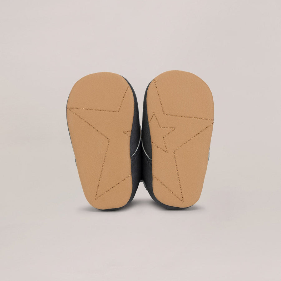 Close-up of a shoe sole with a tan color on a beige background