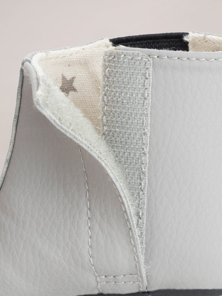 Close-up of a gray shoe with a star design on a light background