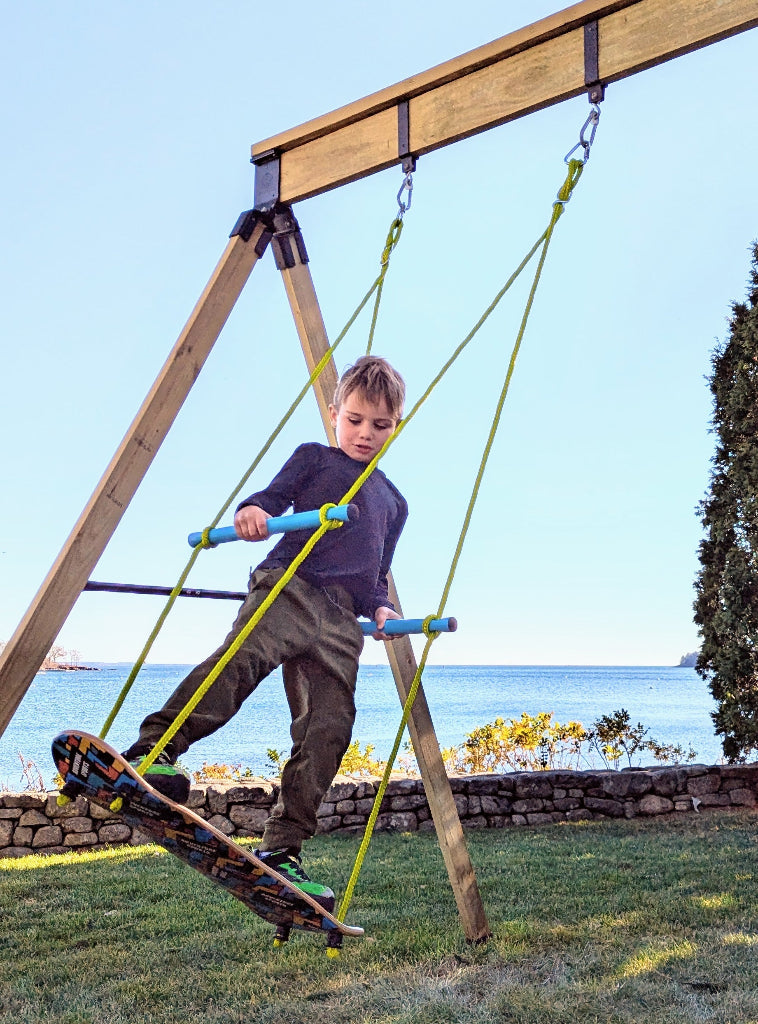 Child playing on a playground structure with a scenic background