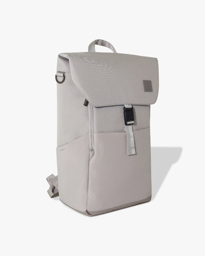 Picture of a three-quarters view of the taupe backpack against a white surface